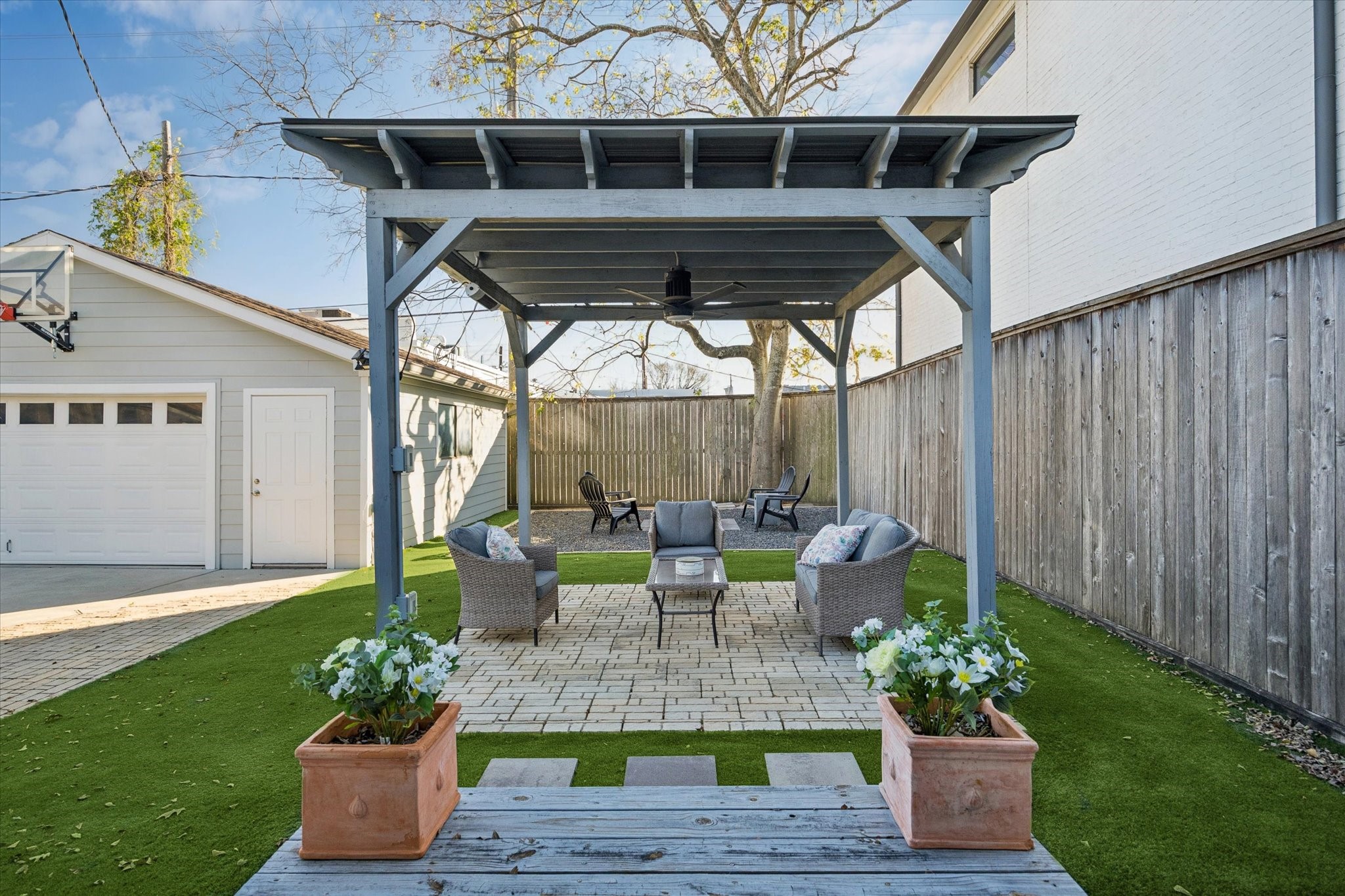 2109 Colquitt Street Houston, TX 77098 - Photo 25 of 28 A covered pergola creates a welcoming outdoor living area, ideal for relaxing or entertaining in the private backyard.