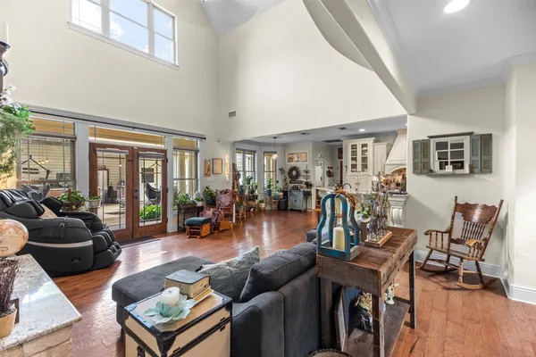 a living room with furniture and wooden floor