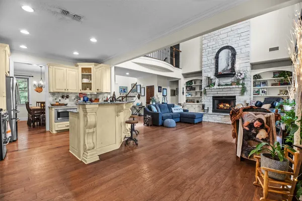 a living room with fireplace furniture and a wooden floor