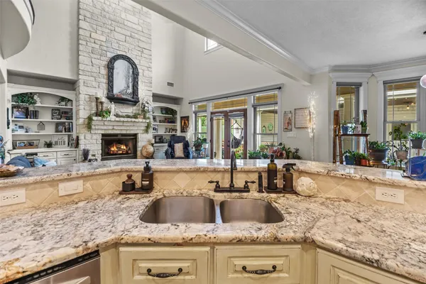a kitchen with granite countertop a sink and a counter top space