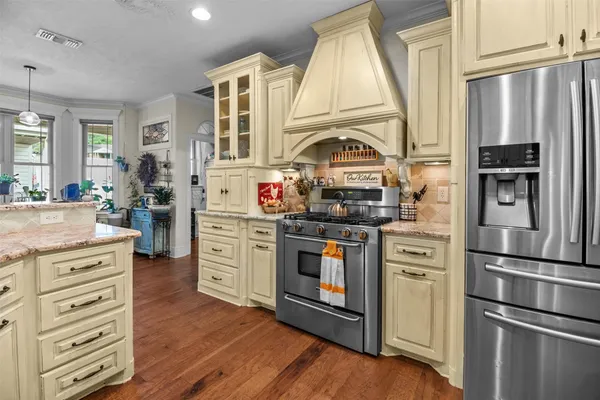 a kitchen with stainless steel appliances a refrigerator stove and cabinets