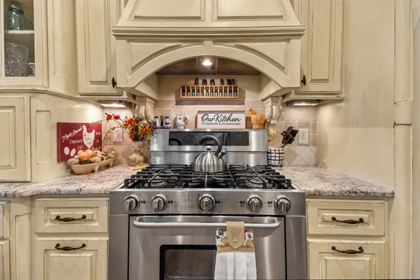 a stove top oven sitting inside of a kitchen