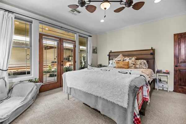 a bedroom with a large bed and a large window
