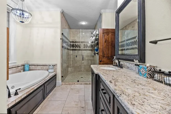 a bathroom with a granite countertop sink a mirror and shower