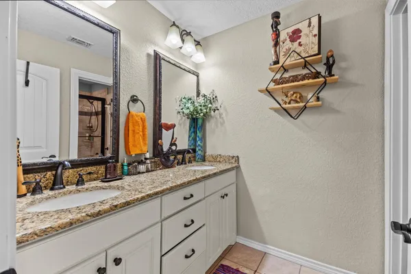 a bathroom with a granite countertop sink mirror and vanity