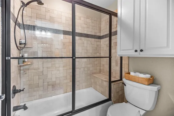 a bathroom with a toilet and a shower