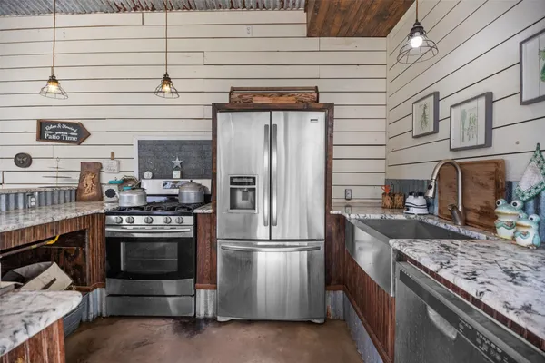 a kitchen with stainless steel appliances granite countertop a stove and a refrigerator