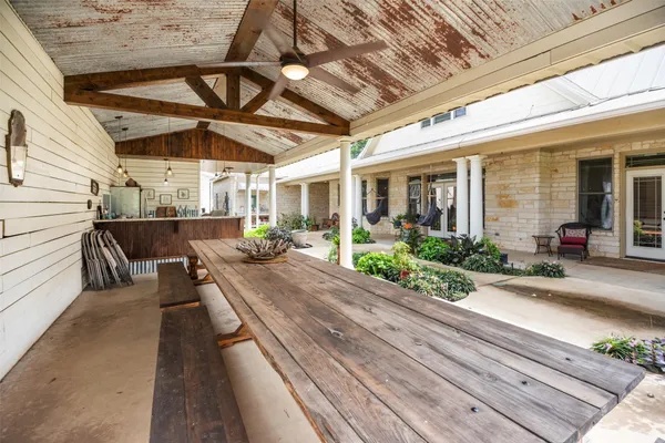 a view of a patio with table and chairs potted plants with wooden floor