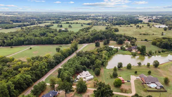 an aerial view of residential houses with outdoor space and swimming pool