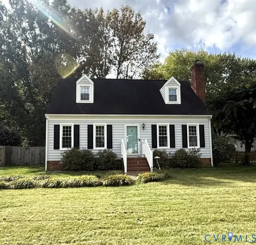 a front view of a house with a yard table and chairs