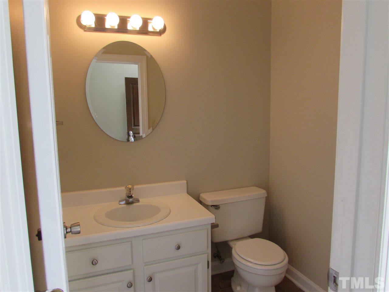 644 Weathergreen Drive Raleigh, NC 27615 - Photo 13 of 24 a bathroom with a toilet a sink and mirror