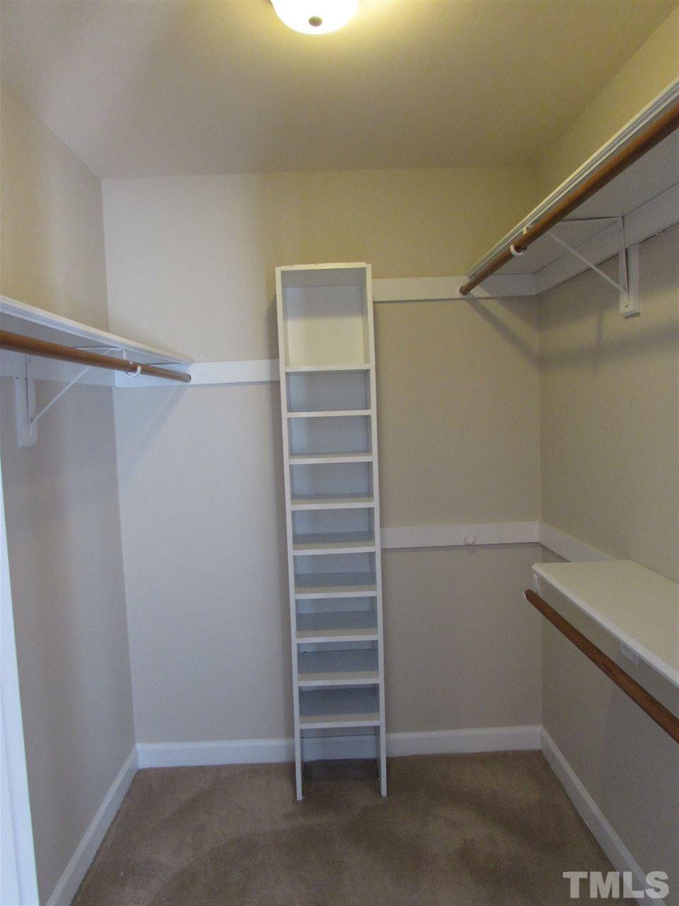 644 Weathergreen Drive Raleigh, NC 27615 - Photo 16 of 24 a view of walk in closet with empty racks