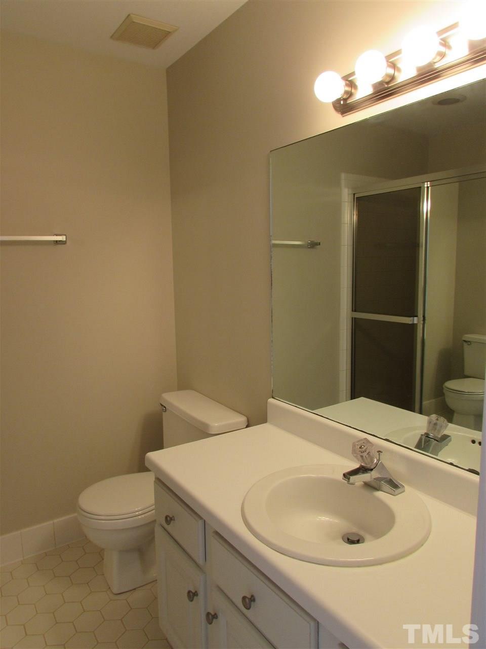 644 Weathergreen Drive Raleigh, NC 27615 - Photo 17 of 24 a bathroom with a sink and a toilet