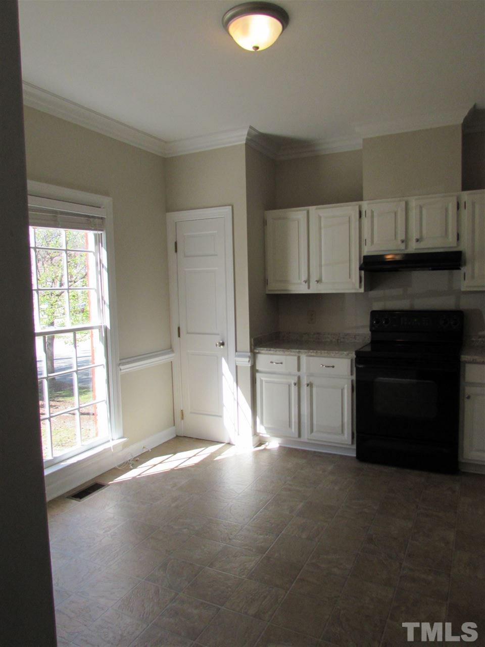 644 Weathergreen Drive Raleigh, NC 27615 - Photo 3 of 24 a kitchen with a stove a sink and a microwave