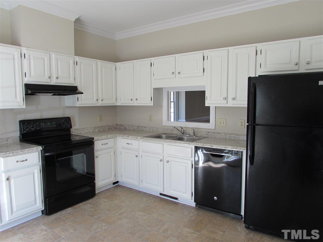 644 Weathergreen Drive Raleigh, NC 27615 - Photo 4 of 24 a kitchen with cabinets appliances and a counter space