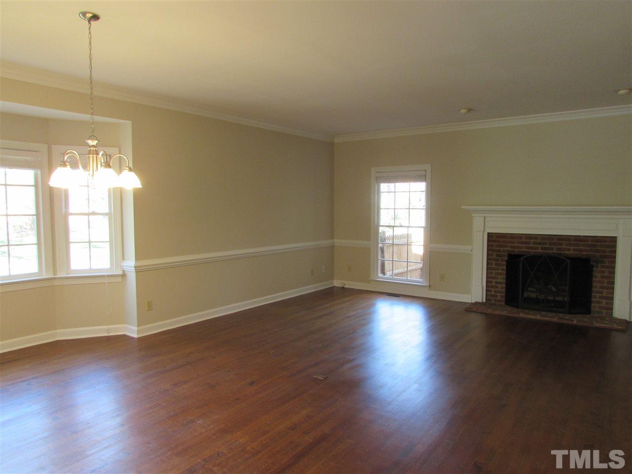 644 Weathergreen Drive Raleigh, NC 27615 - Photo 5 of 24 a view of an empty room with wooden floor and a window