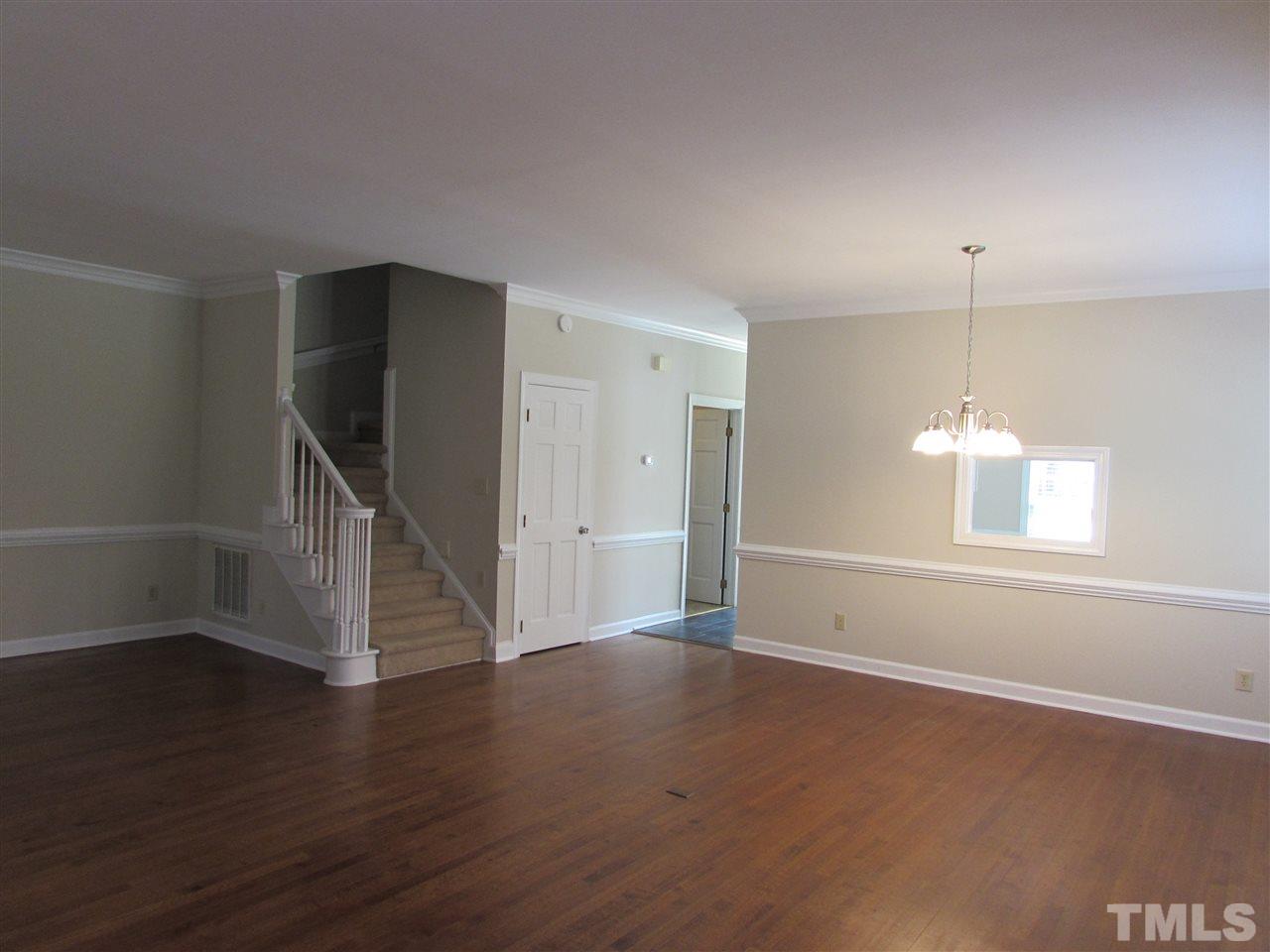 644 Weathergreen Drive Raleigh, NC 27615 - Photo 7 of 24 an empty room with wooden floor and windows