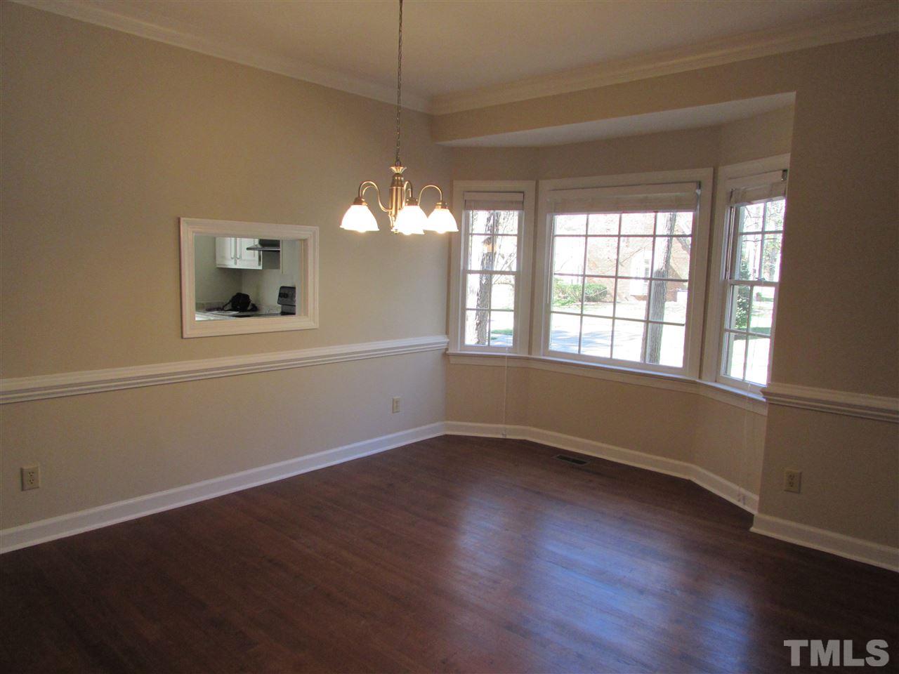 644 Weathergreen Drive Raleigh, NC 27615 - Photo 8 of 24 an empty room with wooden floor and windows