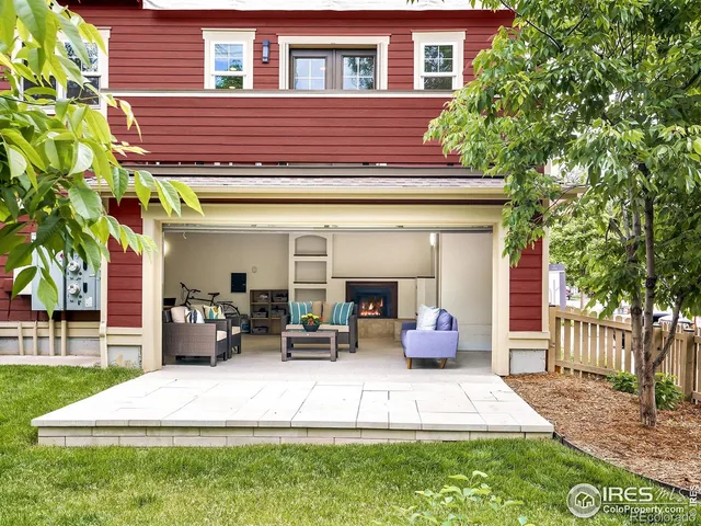 a view of a patio with couches chairs potted plants and a big yard