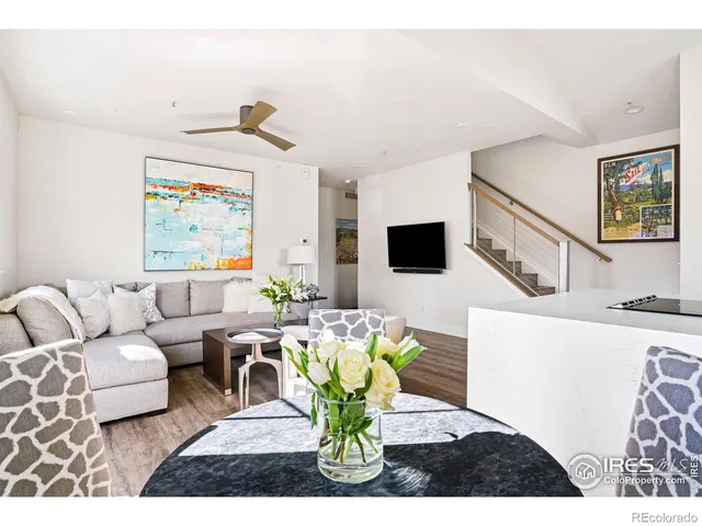 a living room with furniture flowerpot and a flat screen tv