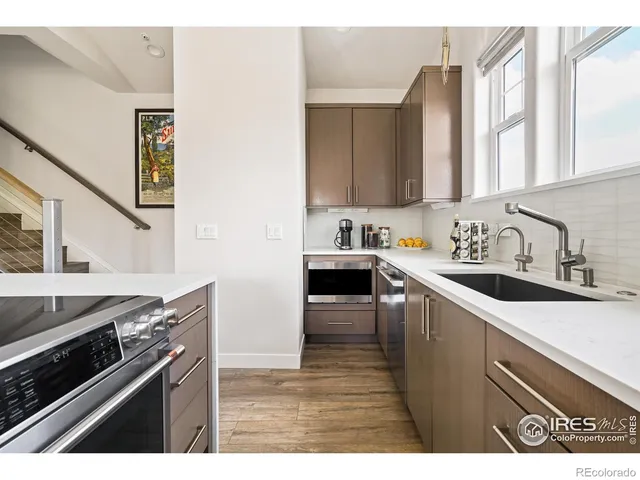 a kitchen with a sink cabinets and appliances