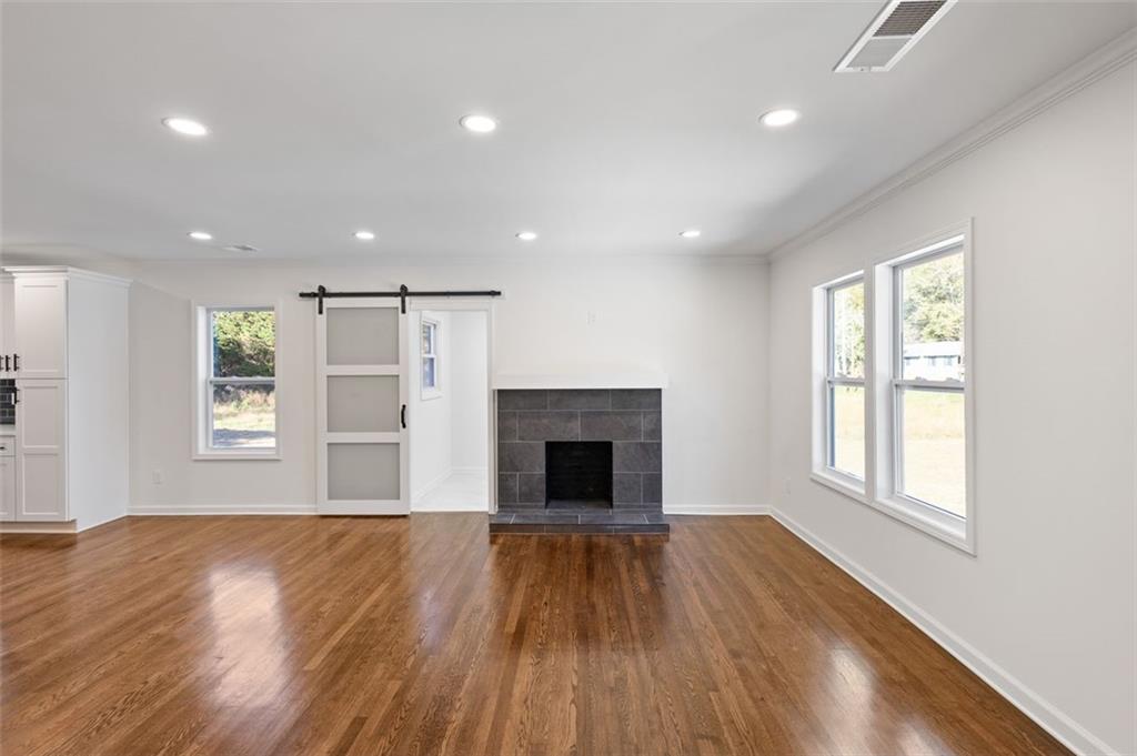 159 Pine Valley Road Bogart, GA 30622 - Photo 11 of 40 a view of an empty room with wooden floor and a window