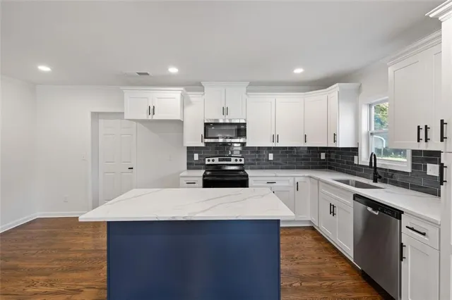 a kitchen with a sink and white cabinets