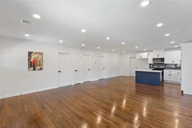 a large kitchen with kitchen island a sink stainless steel appliances and cabinets