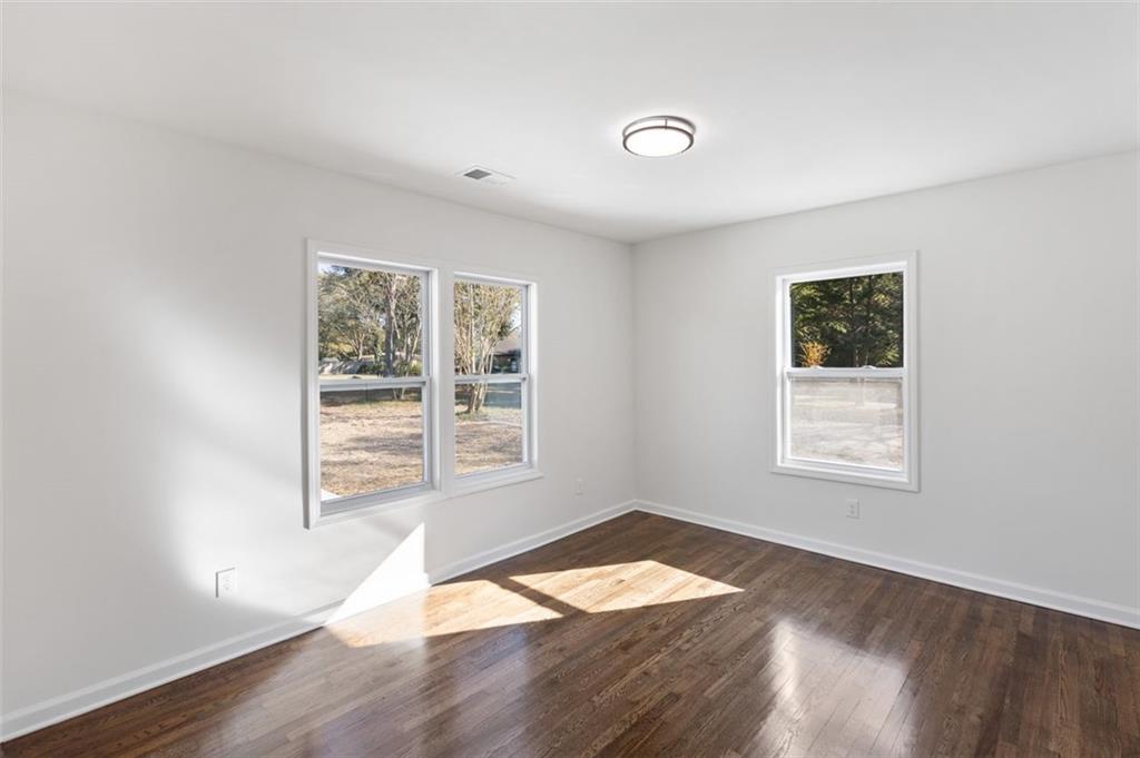 159 Pine Valley Road Bogart, GA 30622 - Photo 17 of 40 an empty room with wooden floor and windows