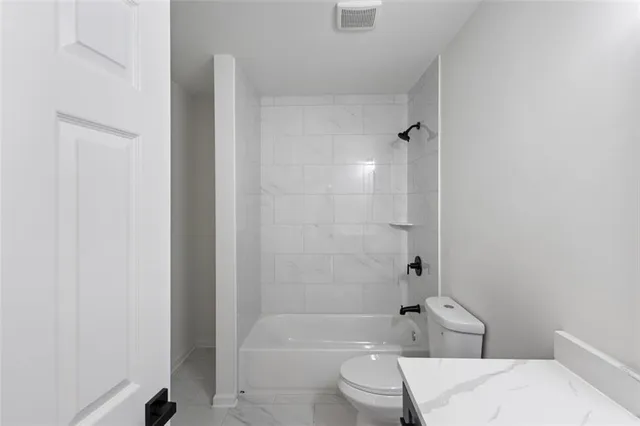a bathroom with a toilet and shower