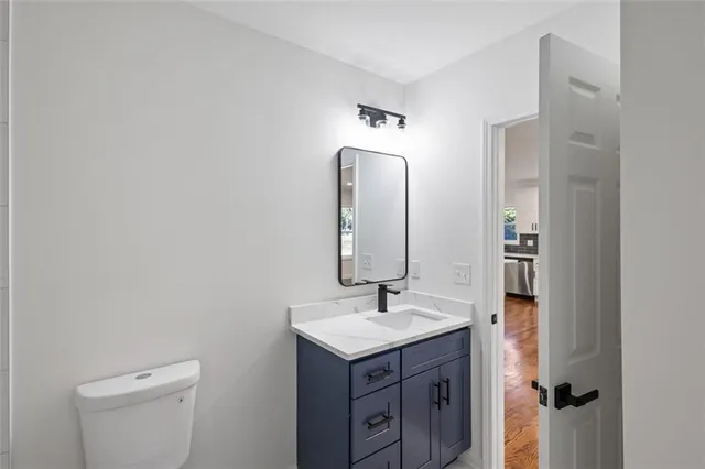 a bathroom with a sink vanity and mirror