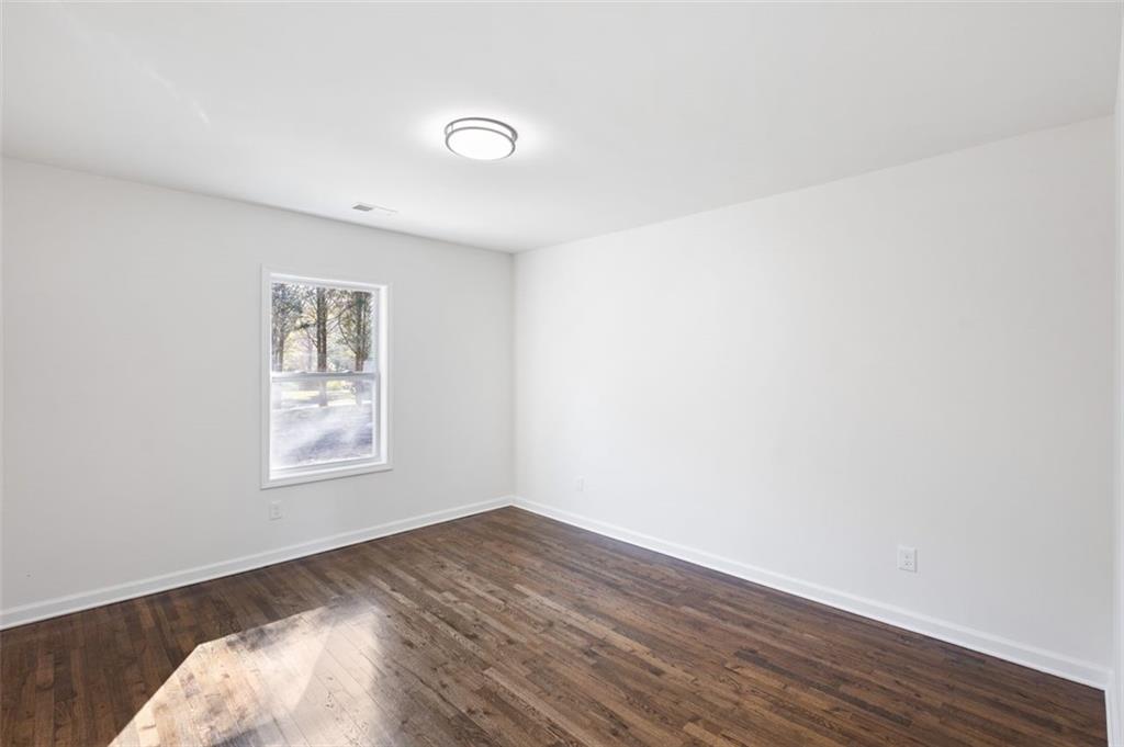 159 Pine Valley Road Bogart, GA 30622 - Photo 22 of 40 an empty room with wooden floor and windows