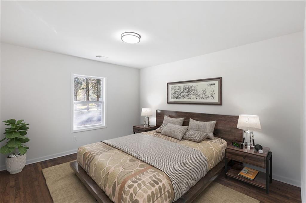 159 Pine Valley Road Bogart, GA 30622 - Photo 23 of 40 a bedroom with a large bed and a potted plant