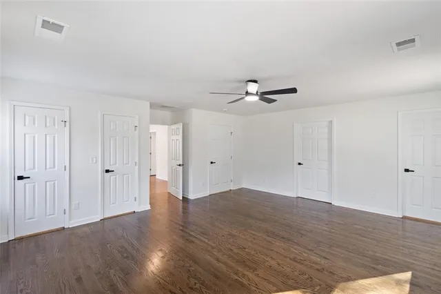 a view of a room with wooden floor