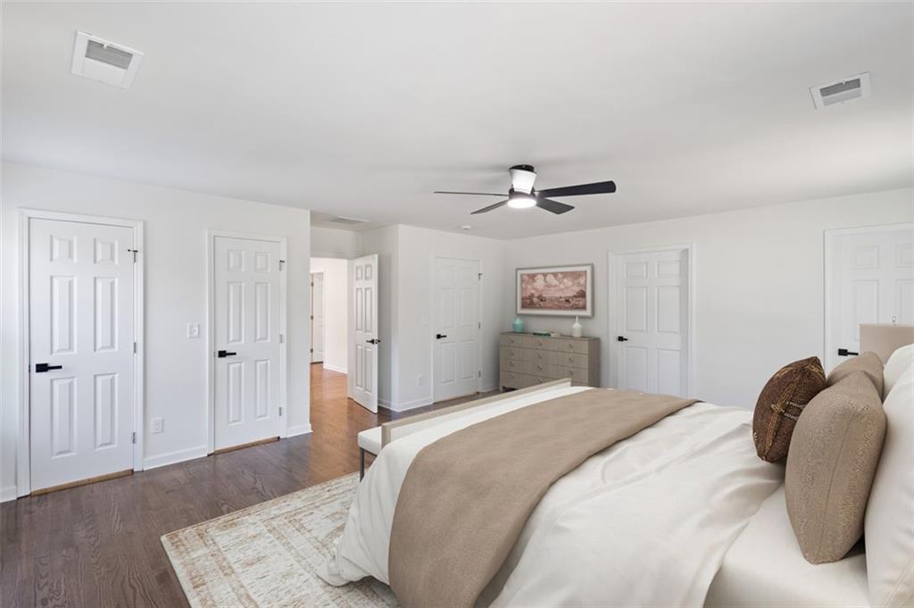 159 Pine Valley Road Bogart, GA 30622 - Photo 28 of 40 a bedroom with a bed and a chandelier