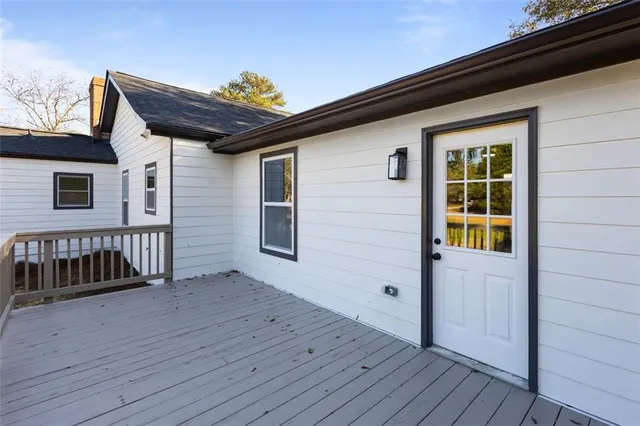 a view of wooden house with a large window and wooden floor