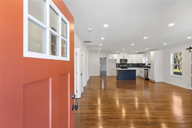 a view of kitchen dining table chairs microwave and stove