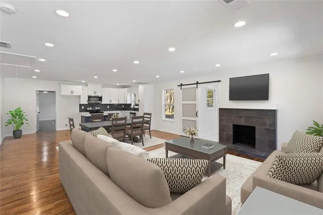 a living room with furniture and a fireplace