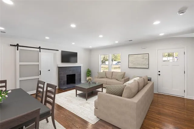 a living room with furniture a fireplace and a table