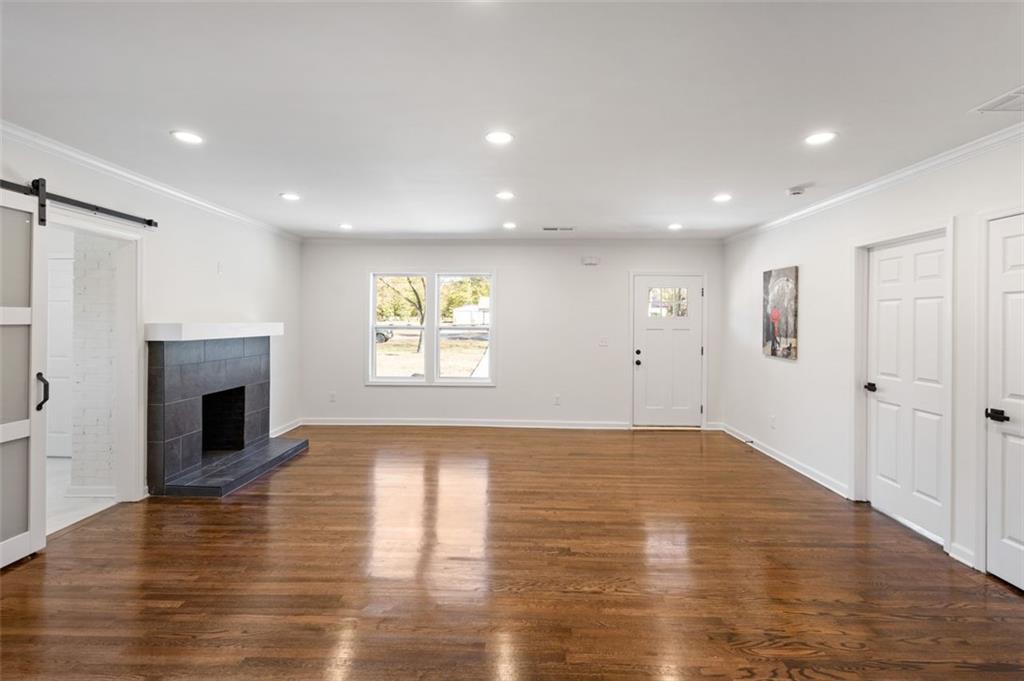 159 Pine Valley Road Bogart, GA 30622 - Photo 10 of 40 a view of empty room with wooden floor and fireplace