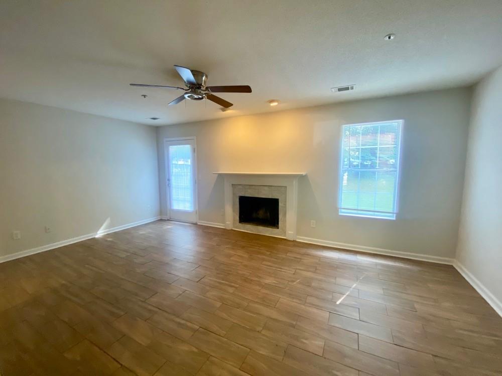 3746 Soapstone Road Decatur, GA 30034 - Photo 12 of 13 an empty room with windows and fireplace