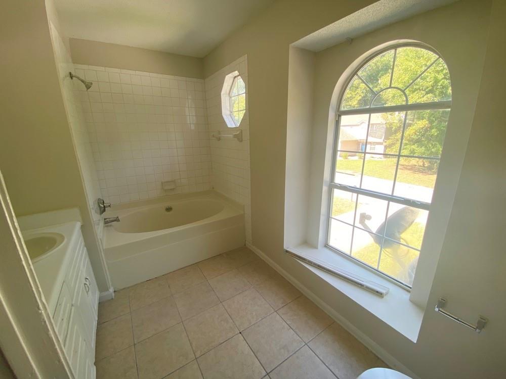 3746 Soapstone Road Decatur, GA 30034 - Photo 13 of 13 a bath room with a bath tub and a window