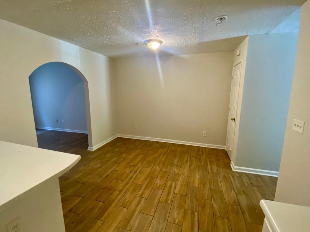3746 Soapstone Road Decatur, GA 30034 - Photo 3 of 13 a view of an empty room with wooden floor and a chair