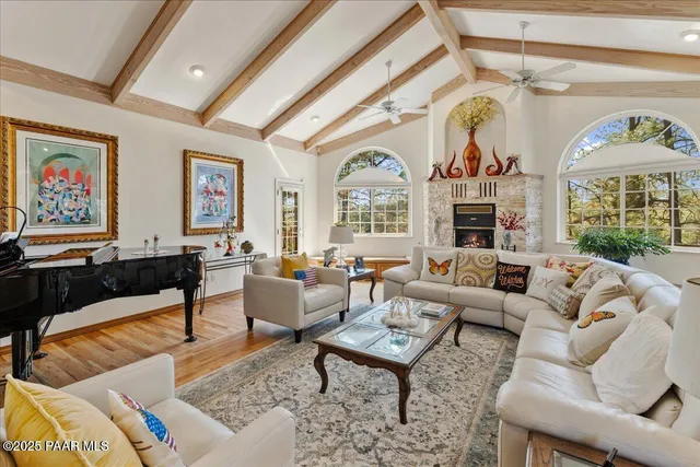 a living room with fireplace furniture and a large window