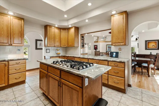 a large white kitchen with a large window