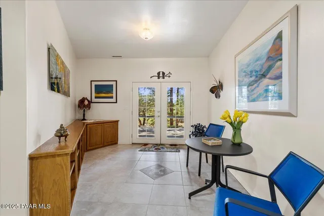 a spacious bedroom with a bed and a large window with the outer view