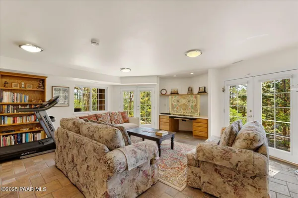 a bedroom with a bed and a flat tv screen on the dresser