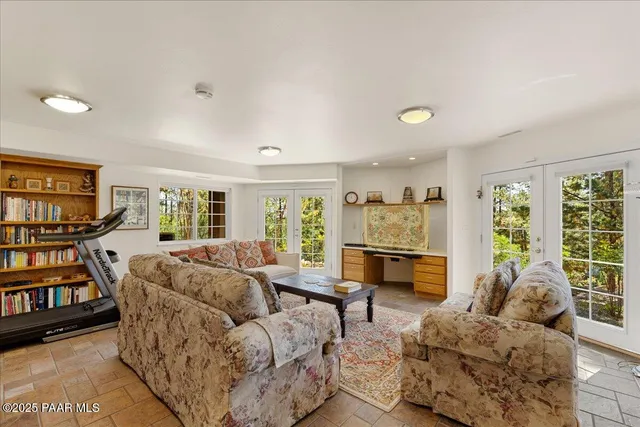 a bedroom with a bed and a flat tv screen on the dresser