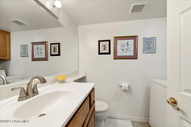 a living room with furniture a bookshelf and a window