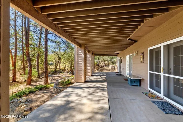 front view of a house with a large tree